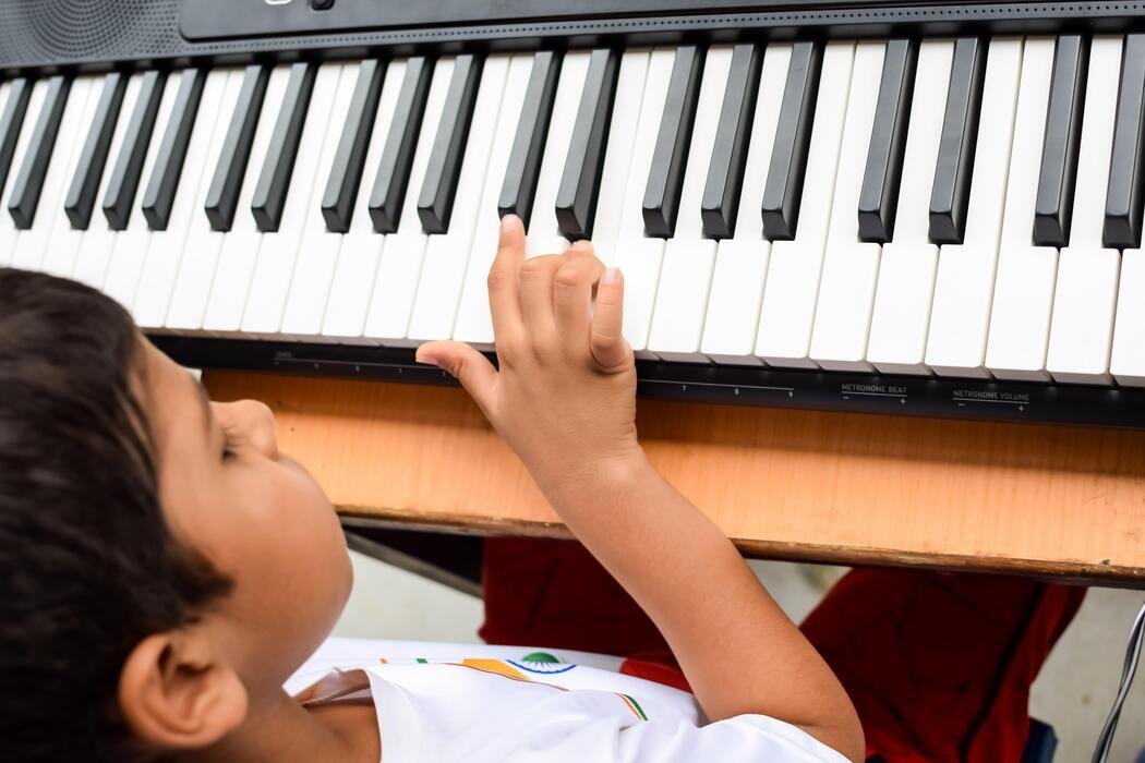 Child learning to play piano